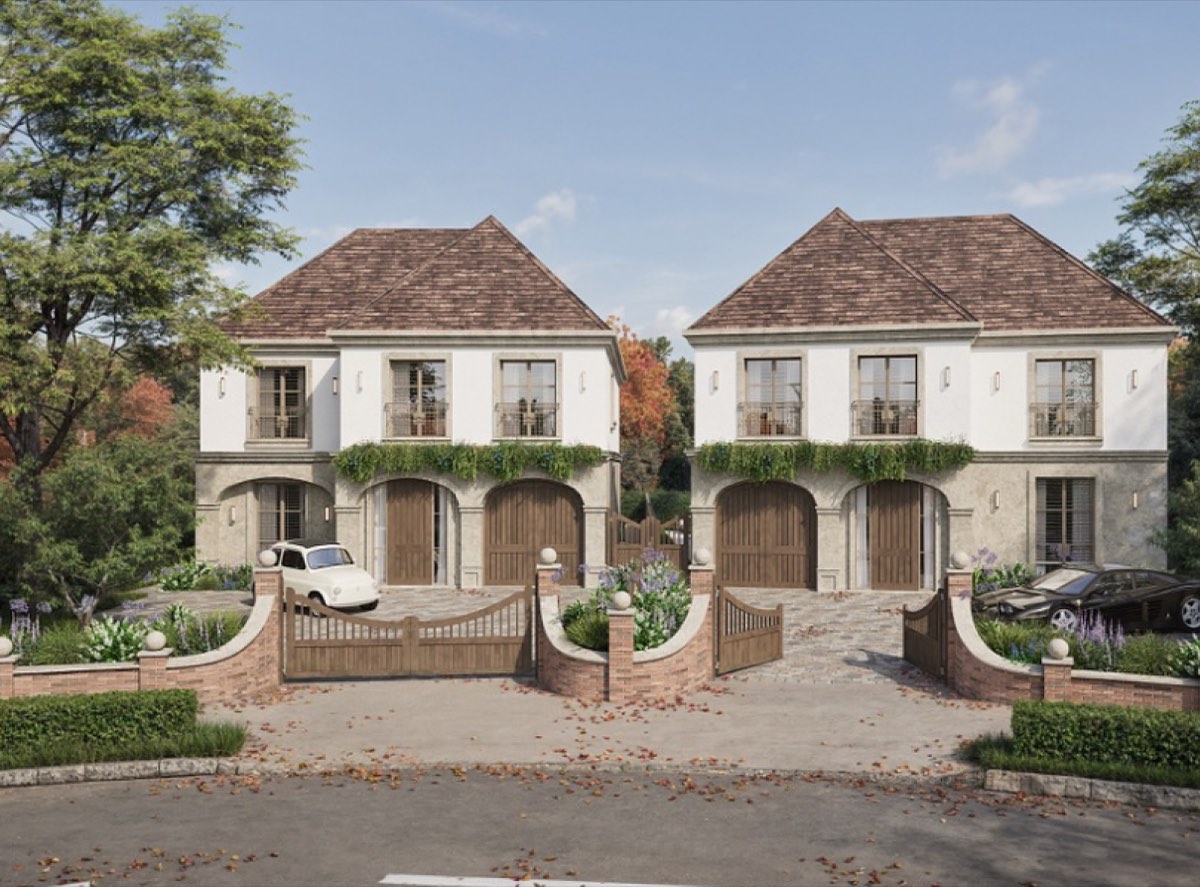 Rendered pair of stone-fronted townhouses with arched garages, developed by Glass Harbour Group